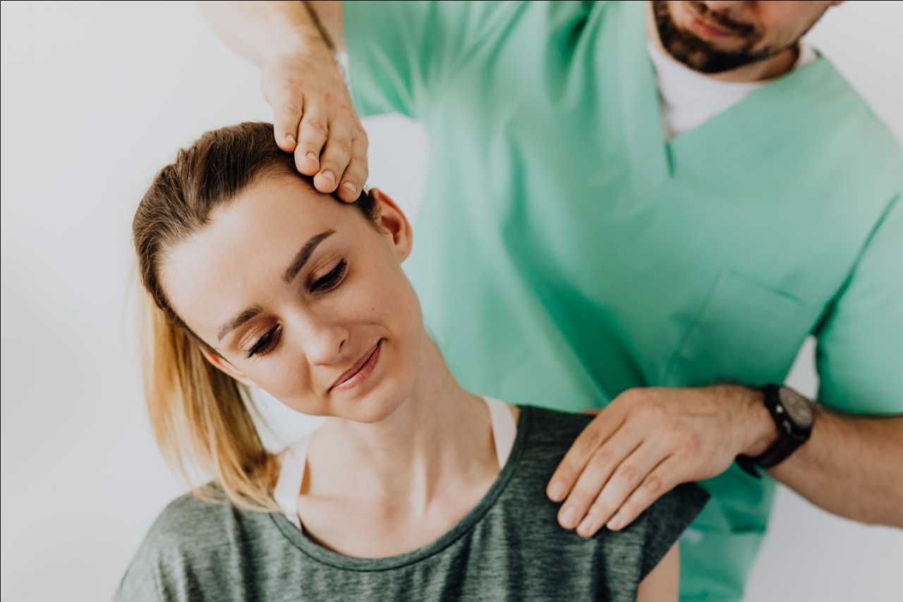  a chiropractor adjusting a woman’s neck